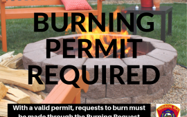 Photo of a round stone fire pit with flames with the words Burning Permit Require across the photo.