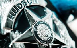 Close-up of Silver metal Hudson Police badge