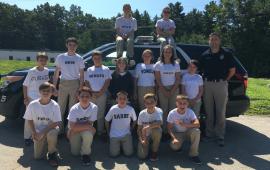 2017 Youth Police Academy Class posing infront of marked police cruiser