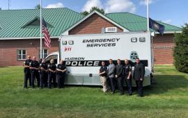 Crime Scene Investigation team members standing infront of Emergency Operations Vehicle