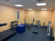 Orange walled room with various fitness equipment