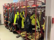 Red racks filled with firefighter gear