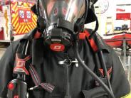 Photo of a firefighter with his facepiece on