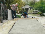 Image of two men pouring a concrete slab.