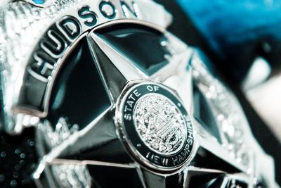 Close-up of Silver metal Hudson Police badge